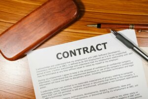 A close-up view of a contract and pen on a wooden desk, ideal for business themes.